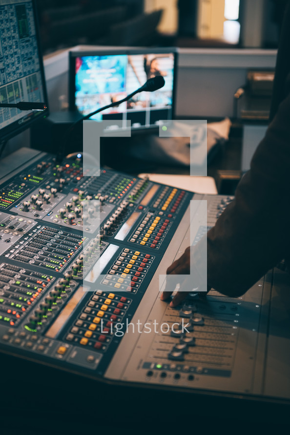 a woman in the control room and a soundboard 