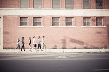 youth walking on a sidewalk 