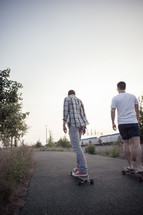 teen boys on skateboards on a sidewalk 