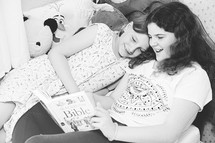 sisters reading a Bible in bed 