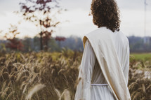 Jesus standing in a wheat field 