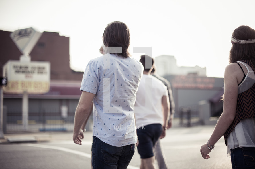 teens walking on a road together 