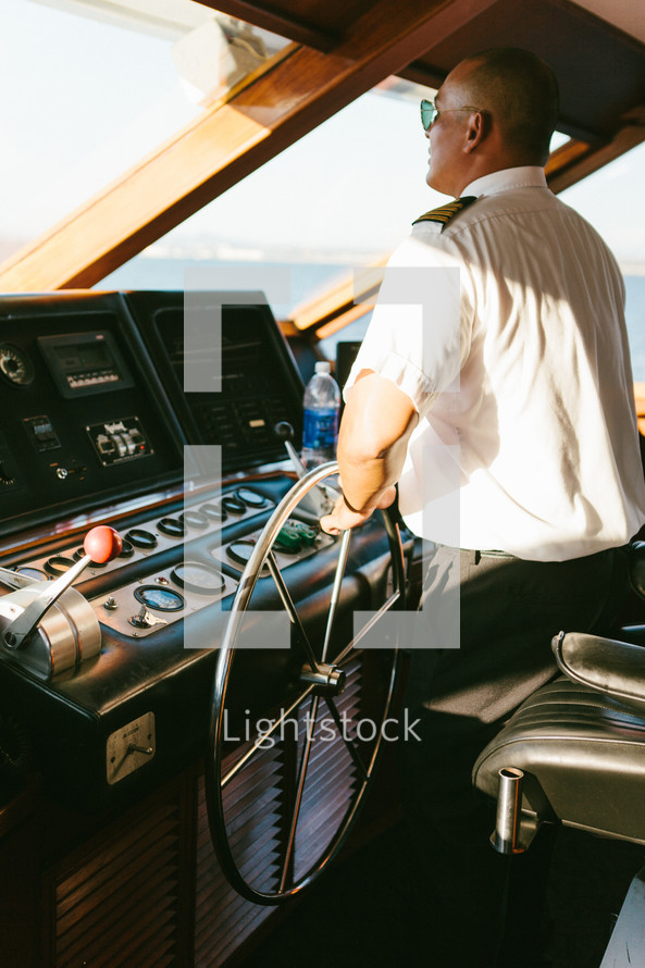 Captain at the helm of a ship.