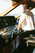 Captain at the helm of a ship.