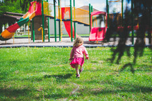 a child walking towards a playground 
