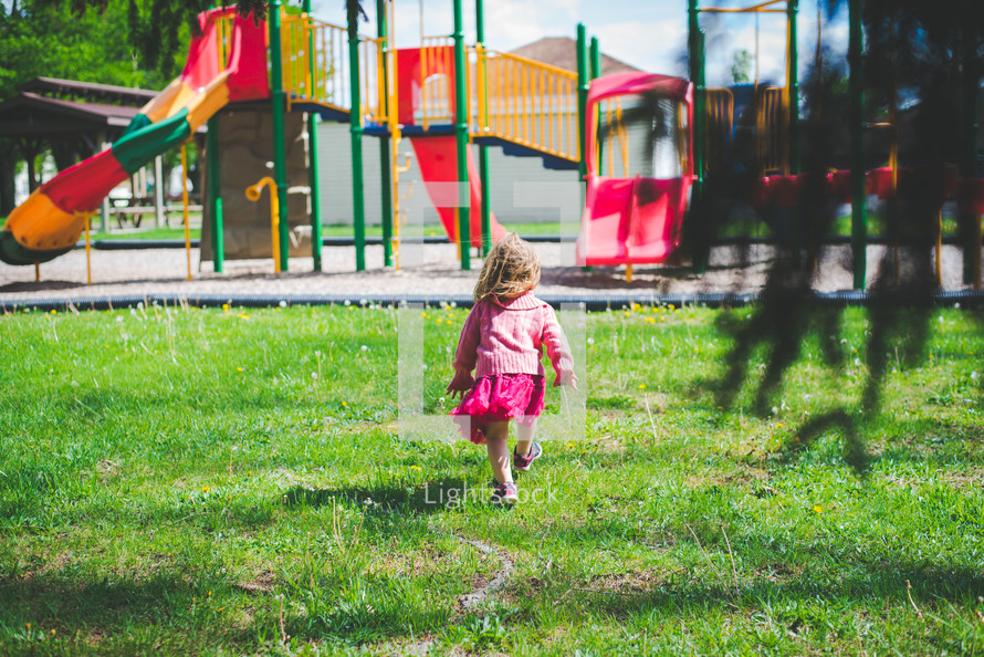 a child walking towards a playground 