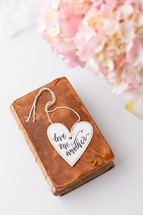 love one another on a heart on an old book 