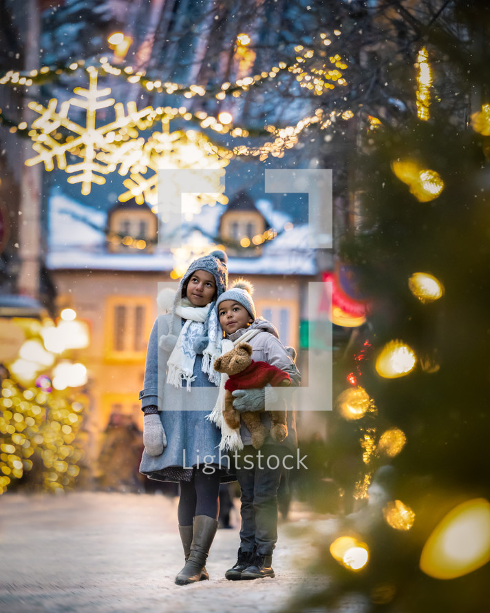 kids hugging in winter snow 