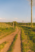 rural dirt road and power lines 