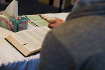 a man reading a Bible at a Bible study 