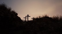 Three empty crosses on Golgotha hill at dawn