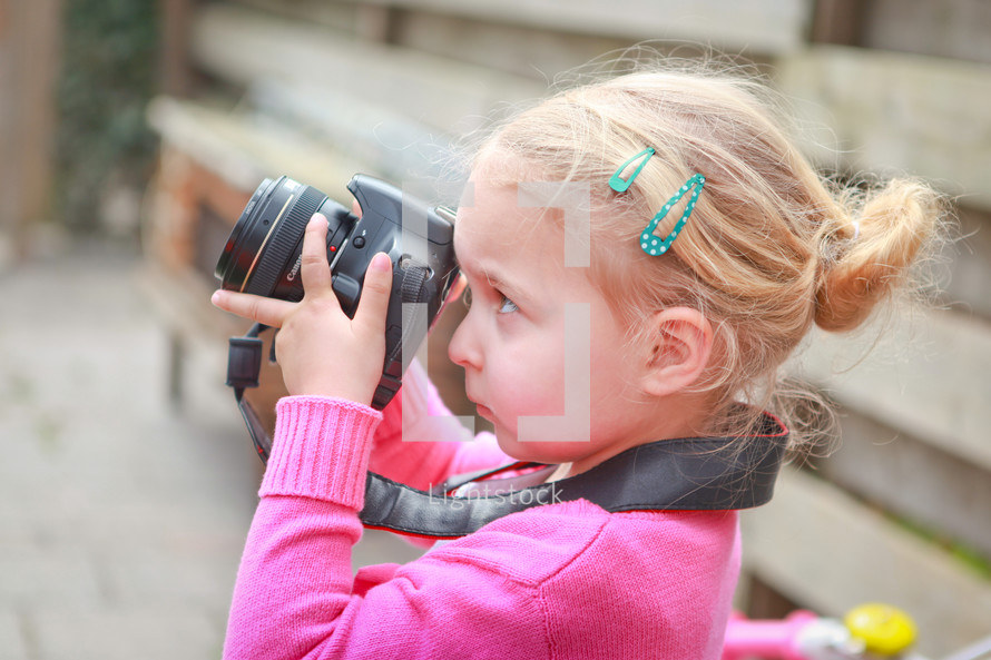 a child with a camera taking a picture 