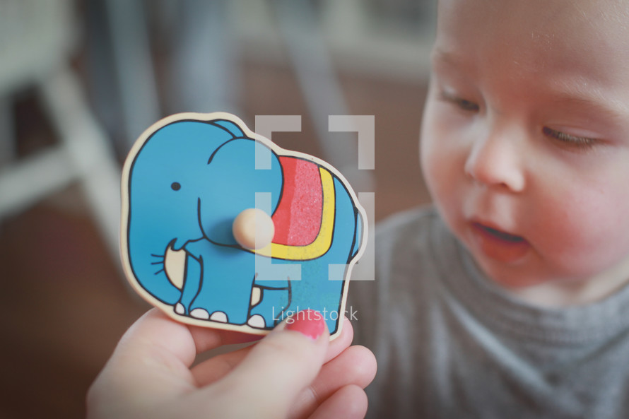 a baby playing with a puzzle 