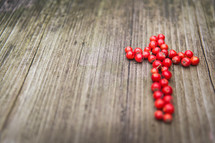cross of red berries 