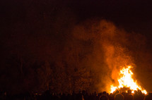 crowds around a bonfire 