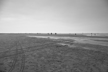 tire tracks on the sand of a beach 