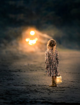 a girl holding a glowing lantern 