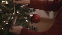 a child decorating a Christmas tree 