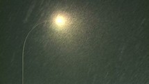 snow fall and a street light