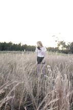 Woman standing in a field of whaet.