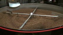 Coffee beans in a mixing sifter.