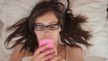 teen girl texting lying down 