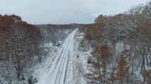 aerial view over snow on train tracks 