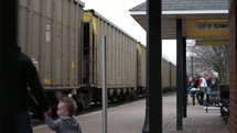 Father and son at a train depot.