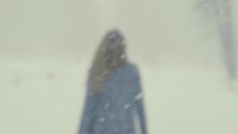 A woman walking in a snow storm