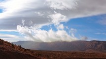 clouds rolling over desert mountains 
