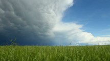 storm clouds approaching over a field 