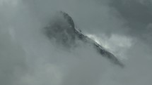 Timelapse of clouds moving over mountains.