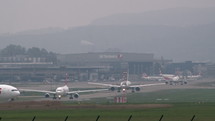 Airplanes lined up at airport to take off