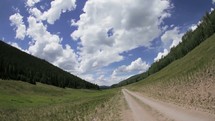 clouds moving over a dirt road time-lapse 