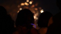 bokeh fireworks and silhouettes of children. 