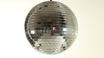a spinning mirror ball against white background
