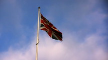 Tattered flag of the United Kingdom blowing in the wind.