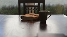 closed Bible and a steaming cup of coffee 