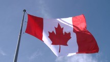 Canadian flag wavering in the wind.