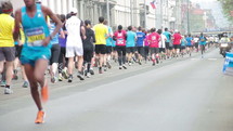 Marathons runners running through the streets.