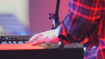 hands playing a digital keyboard 