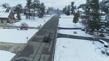 a car driving on a neighborhood street in winter 