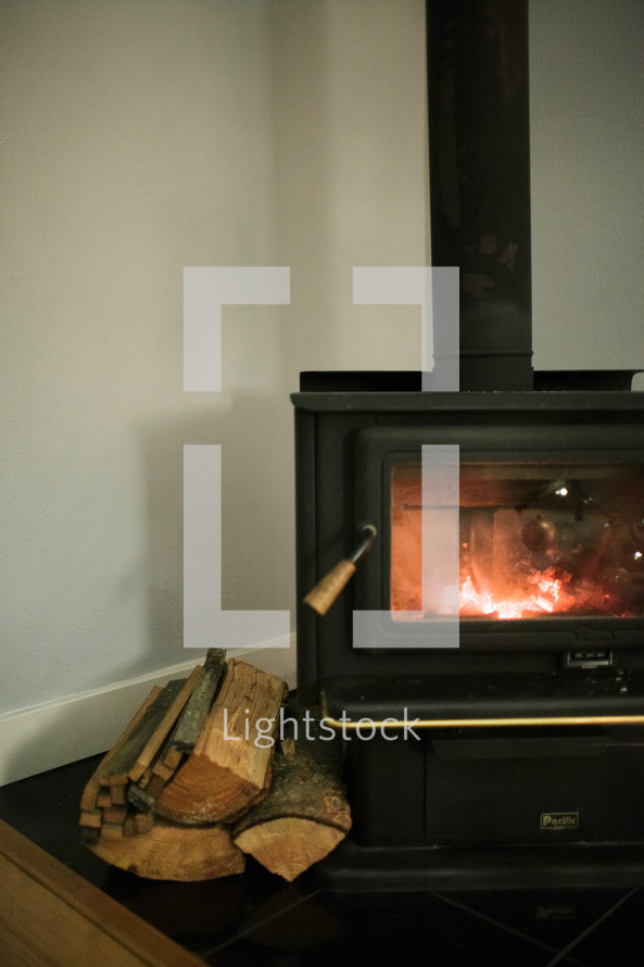 logs next to a fireplace 