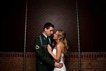 bride and military groom holding each other