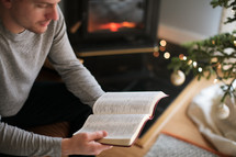 man reading a Bible at Christmas time 
