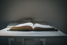 an open Bible on a stand 