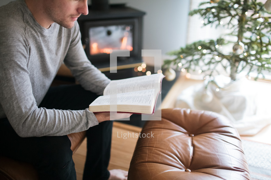 a man reading a Bible at Christmas time 