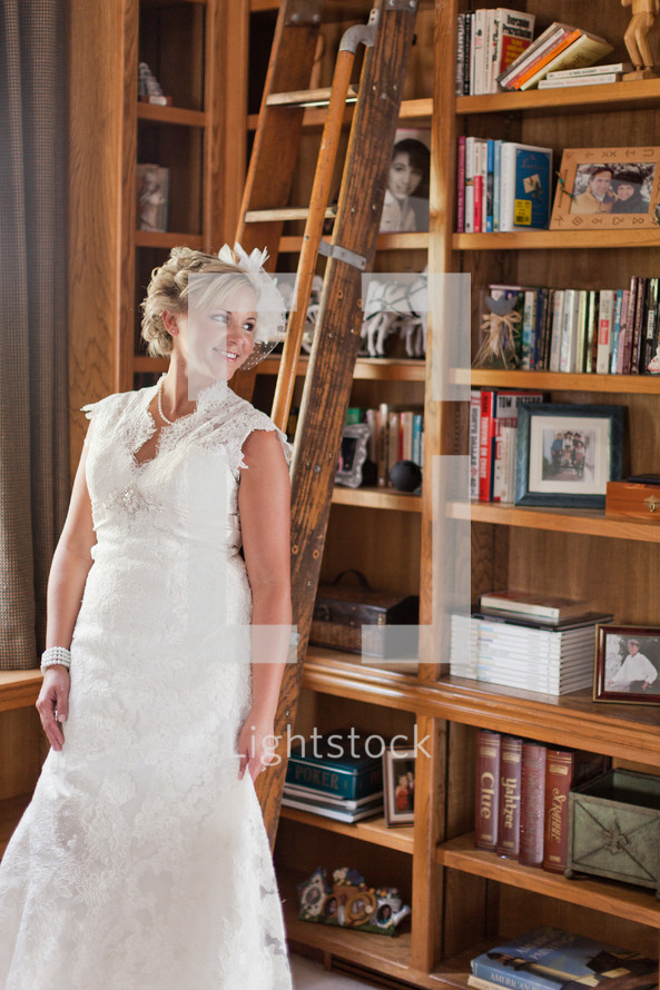 Bride standing in a library