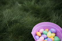 bucket of Easter eggs in grass 