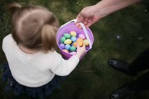 a toddler girl on an Easter egg hunt 